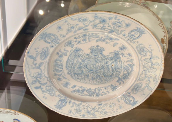 A white plate with intricate blue designs and motifs