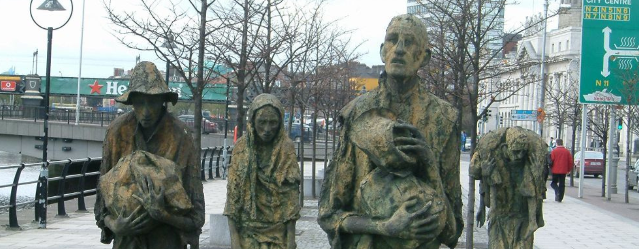 The Dublin Famin Memorial on the Quays. four statues of hungry looking people walking