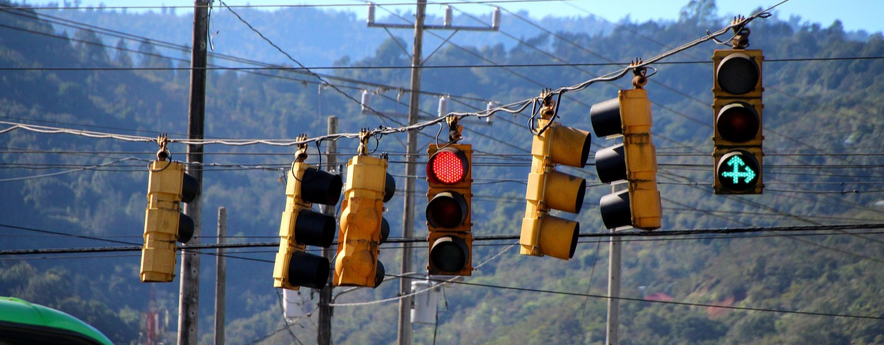 7 traffick lights either facing different ways or giving mixed messages